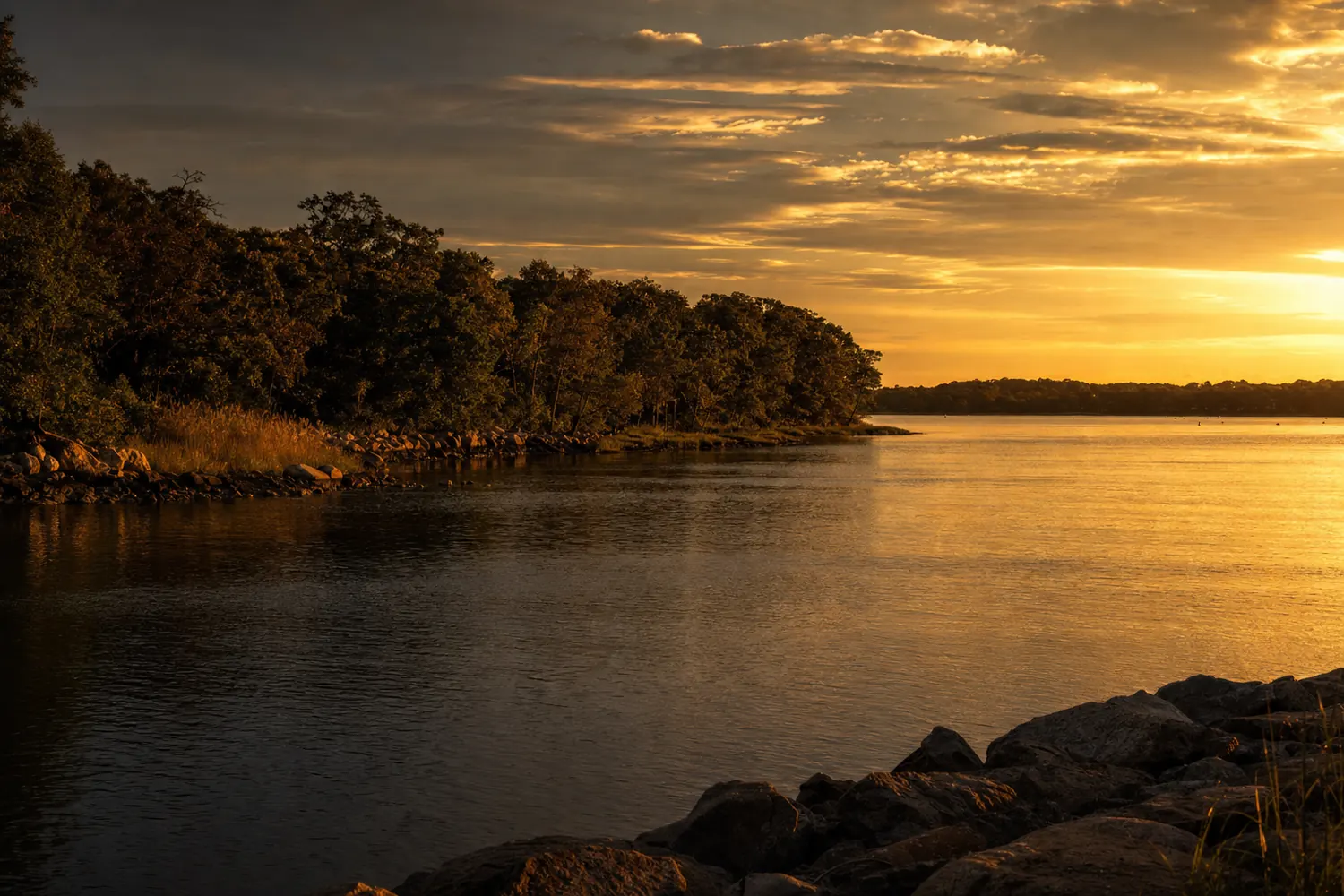 A north shore Long Island harbour at Huntington at sunset, still water and wooded shoreline.