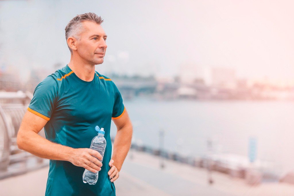 a man after jogging with a bottle of water